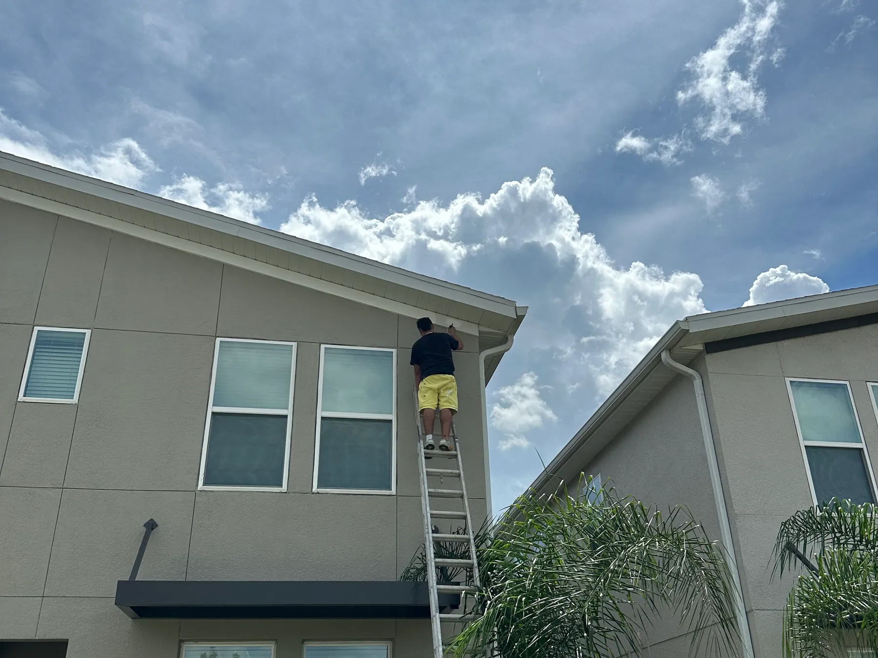 Hyper Go crew cutting in fascia from a ladder
