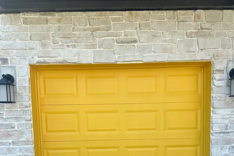Garage door refinished in a custom yellow